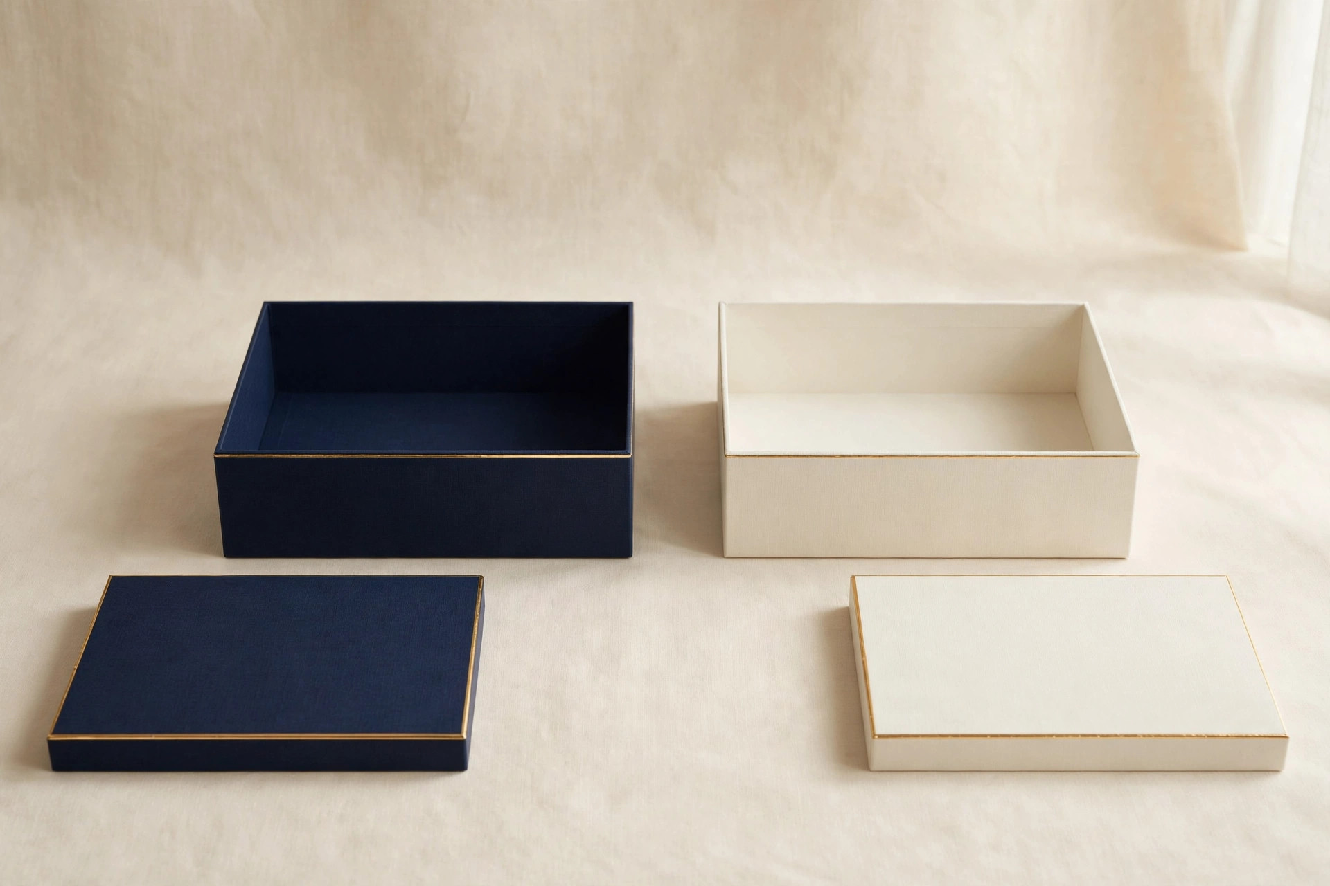 Luxury rigid gift boxes in navy and cream with gold trim
